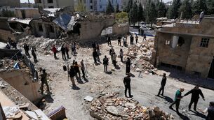 Journalists from foreign media based in Tehran document damage from US-Israeli strikes in a residential area of the town of Fardis, west of Tehran, Iran (Vahid Salemi/AP)