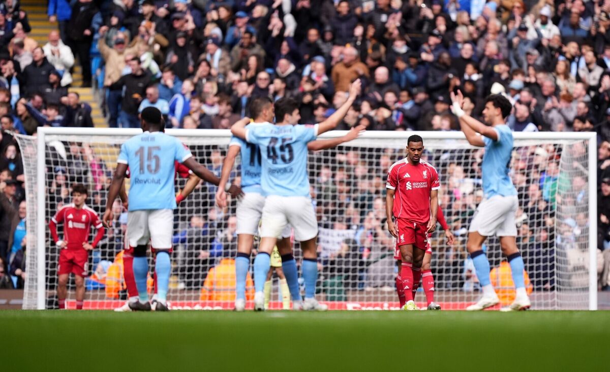 Liverpool's Ryan Gravenberch looks dejected as Manchester City players celebrate their fourth goal. Pic: Mike Egerton/PA
