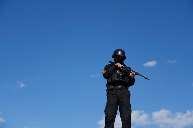 A member of police special forces stands guard at the Enqelab-e-Eslami, or Islamic Revolution, square in downtown Tehran, Iran, Monday, March 30, 2026. (AP Photo/Vahid Salemi)