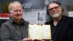 <p>Youghal Film and Photography curator Ed Guirey (left) accepting the autographed copy of Moby Dick from David 'Skully' Sullivan. Picture: Christy Parker</p>