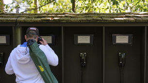 <p>LAND BEFORE TIME: A patron uses the courtesy phones during a practice around at the Masters golf tournament, Wednesday, April 9, 2025, in Augusta, Ga.(AP Photo/Julia Demaree Nikhinson)</p>
