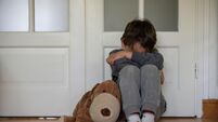 view of a child victim of child abuse in his room