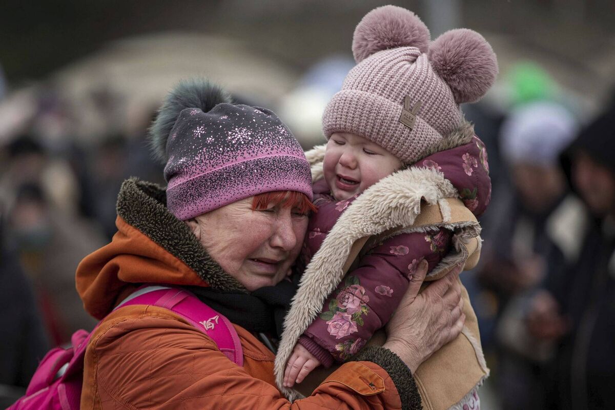 A woman holding a child cries after fleeing from the Ukraine and arriving at the border crossing in Poland. Photo: AP/Visar Kryeziu A woman holding a child cries after fleeing from the Ukraine and arriving at the border crossing in Poland. Photo: AP/Visar Kryeziu