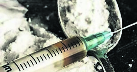 Drug syringe and cooked heroin