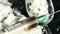 Drug syringe and cooked heroin