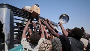 <p>Sudanese families reach out as aid workers distribute food supplies in Al Dabbah, Sudan's Northern State last November. Picture: Marwan Ali/AP</p> <p>Sudanese families reach out as aid workers distribute food supplies in Al Dabbah, Sudan's Northern State last November. Picture: Marwan Ali/AP</p>