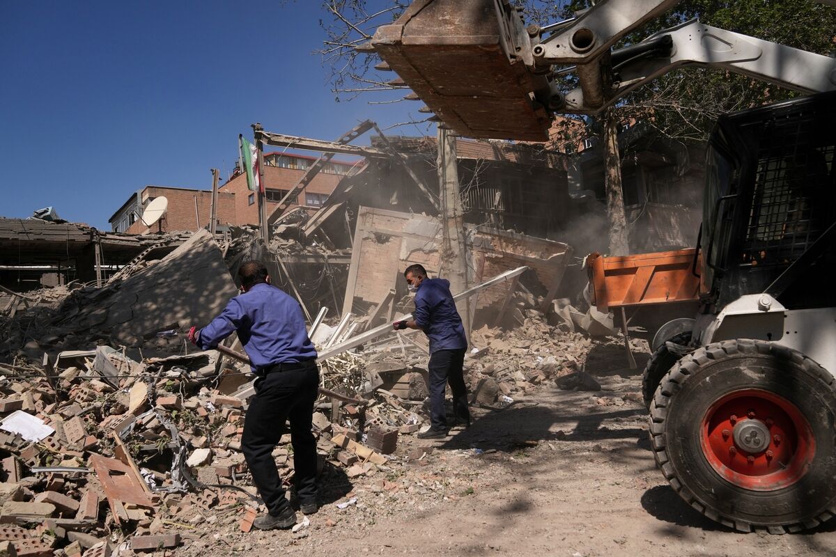 Workers remove debris at Tehran's Sharif University of Technology complex that Iranian authorities say was hit early Monday by a US-Israeli strike. Picture: Francisco Seco/AP