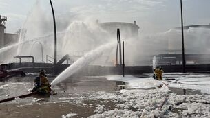 <p>Firefighters extinguishing flames after an Iranian projectile struck an industrial area in Ma’ameer, Bahrain, last month. Picture: Bahrain Interior Ministry via AP, File</p>