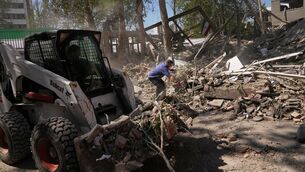 <p>Workers remove debris at Tehran’s Sharif University of Technology complex that Iranian authorities say was hit early Monday by a US-Israeli strike. Picture: Francisco Seco/AP</p>