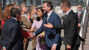 The US vice president, centre right, and his wife Usha, centre left, were greeted at the airport in Budapest by Hungarian foreign minister Peter Szijjarto, right (Jonathan Ernst/Pool Photo via AP)