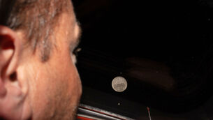 <p>In this photo provided by NASA, Artemis II commander and NASA astronaut Reid Wiseman looks out one of the Orion spacecraft's main cabin windows at the Moon ahead of the crew's lunar flyby on April 6, 2026. (NASA via AP)</p>
