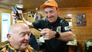 <p> The Baldy Barber, aka Mick Moriarty (seated), cut the ribbon to officially open BuzzCutz Barbershop, run by Donncha O'Connell, who spent 26 years working in The Baldy Barber in Blackpool. Picture: Larry Cummins</p>