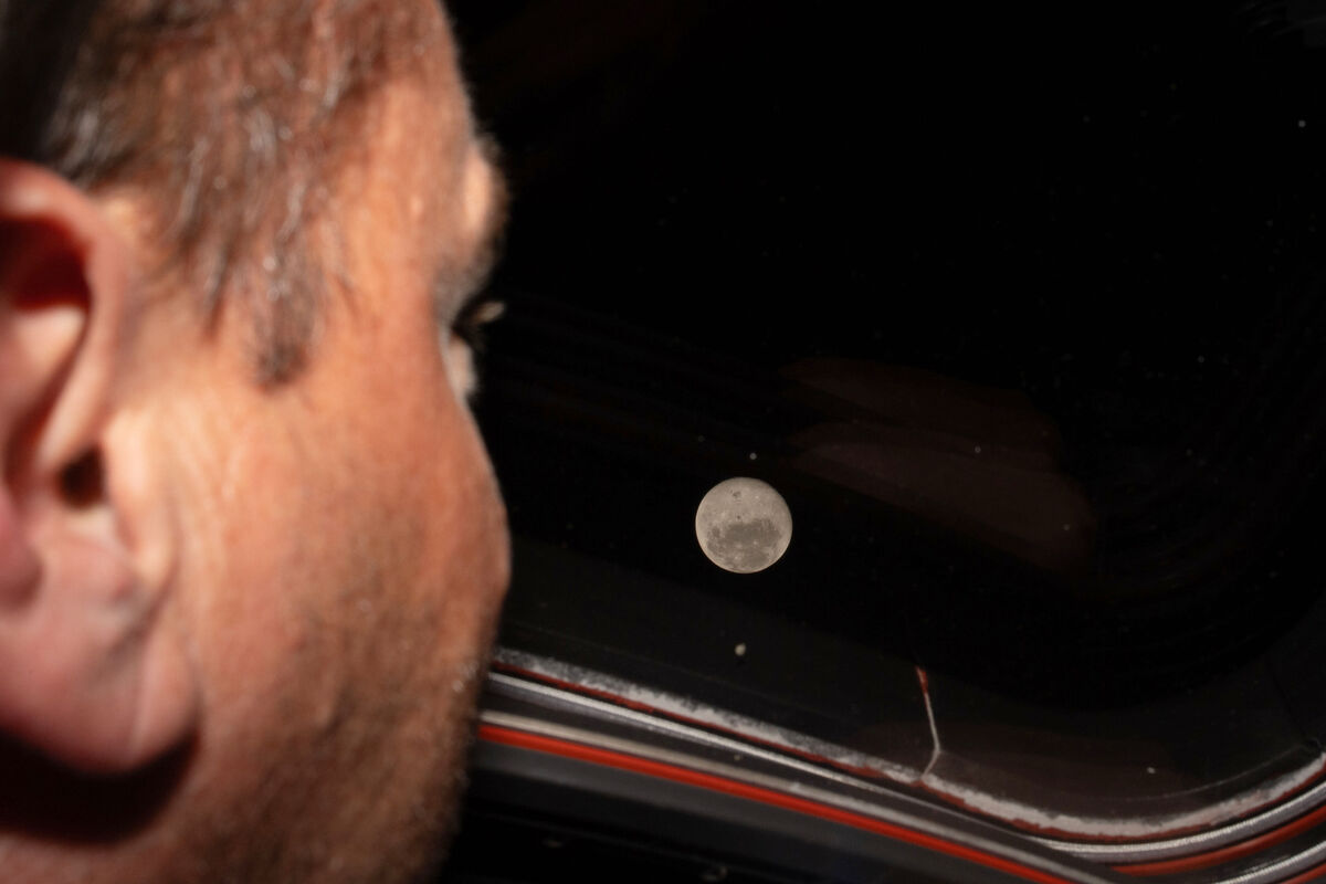 Artemis II commander and Nasa astronaut Reid Wiseman looks out one of the Orion spacecraft's main cabin windows at the moon ahead of the crew's lunar flyby on Monday.