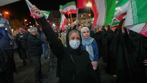 <p>Women hold Iranian flags during a pro-government gathering in a square in Tehran, Iran. Picture: Francisco Seco/AP</p> <p>Women hold Iranian flags during a pro-government gathering in a square in Tehran, Iran. Picture: Francisco Seco/AP</p>