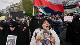 A pro-government demonstrator holds a picture of Iran’s Supreme Leader Mojtaba Khamenei during a gathering following the announcement of a two-week ceasefire with the US and Israel in Tehran, Iran (Francisco Seco/AP)