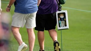 <p>A patron walks with a gnome near the sixth hole during a practice round at of the Masters golf tournament at the Augusta National Golf Club, Monday, April 6, 2026, in Augusta, Ga. (AP Photo/Ashley Landis)</p>