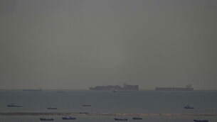Cargo ships sail through the Arabian Gulf toward the Strait of Hormuz (AP)