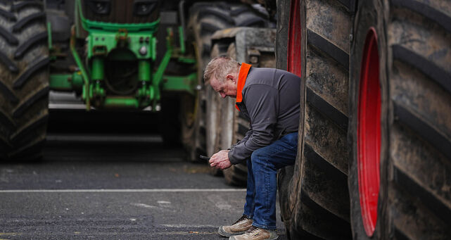 <p>A man sits in a tractor wheel as vehicles are parked on O'Connell Street in Dublin as protestors take part on the second day of a National Fuel Protest against rising fuel prices. Picture: PA</p>