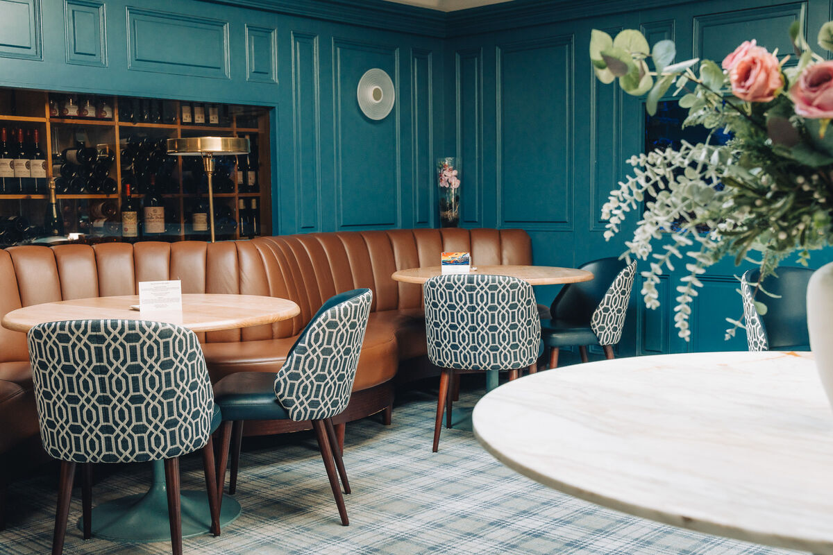 A low, wood-panelled ceiling concentrates intimacy; the bar, along one wall, is festooned with club pennants, a football-themed Mardi Gras float. A low, wood-panelled ceiling concentrates intimacy; the bar, along one wall, is festooned with club pennants, a football-themed Mardi Gras float.