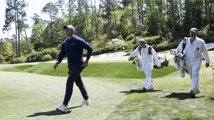 <p>LEADING MAN: First round joint-leader Rory McIlroy strides to the 13th green during his opening 67 at Augusta National. Pic: Andrew Redington/Getty Images</p>