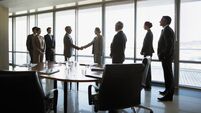 Business people shaking hands in conference room