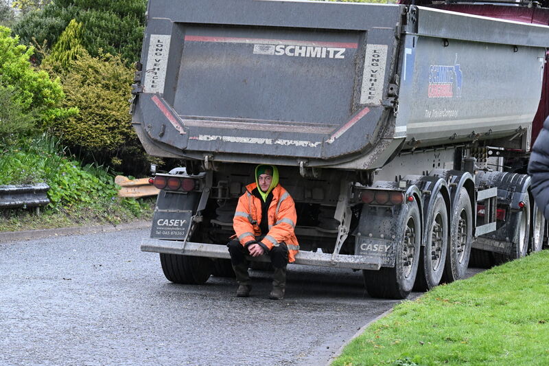  A protester shelters from the heavy rain on Day 4 of the nationwide fuel price protest. The blockade of Irving Oil refinery at Whitegate, Co Cork continues this Friday morning. Picture: Larry Cummins