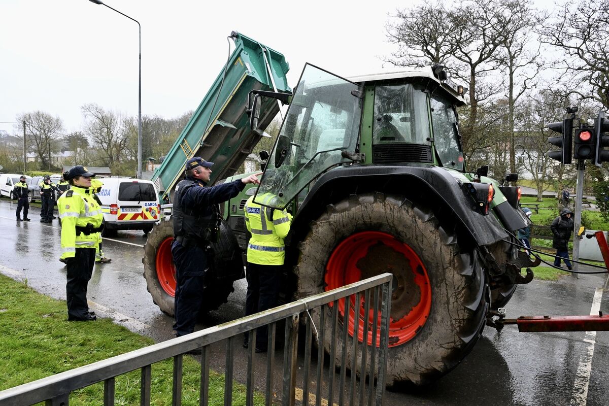  Gardai speak with a tractor driver at the blockade on Friday at Whitegate, Cork. Picture: Larry Cummins