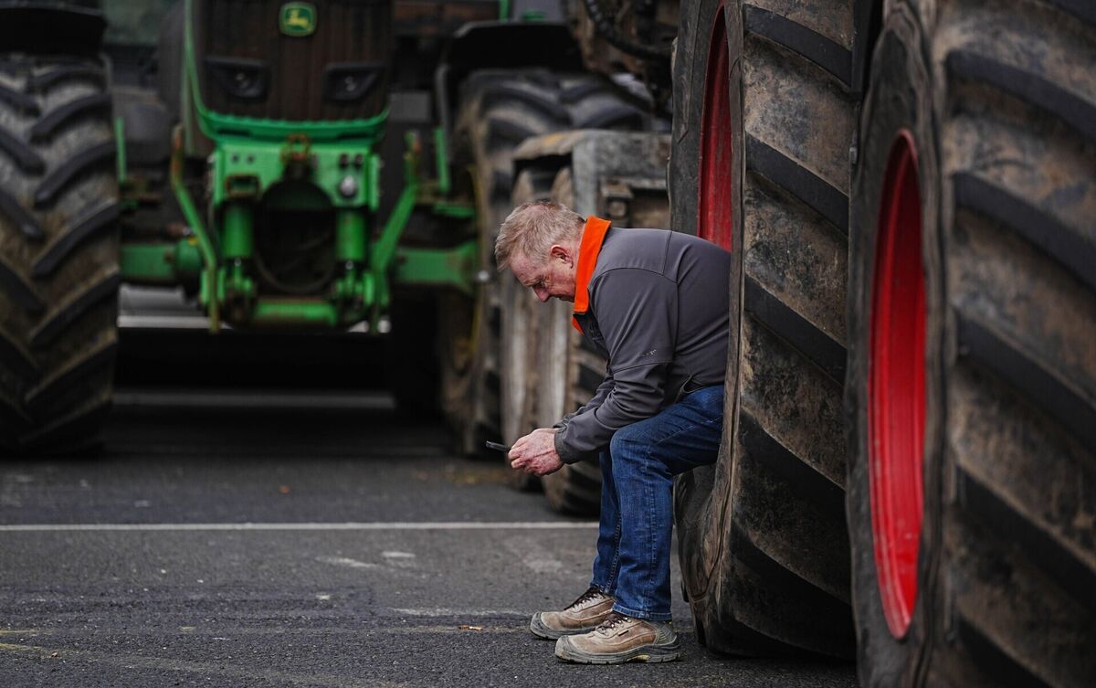 A man sits in a tractor wheel as vehicles are parked on O'Connell Street in Dublin as protesters take part in a National Fuel Protest against rising fuel prices. Picture: Brian Lawless/PA Wire A man sits in a tractor wheel as vehicles are parked on O'Connell Street in Dublin as protesters take part in a National Fuel Protest against rising fuel prices. Picture: Brian Lawless/PA Wire