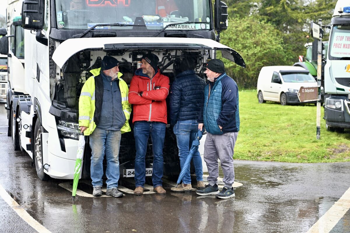  Protesters shelter under the bonnet of a truck during heavy rain on Friday at Whitegate, Cork. Picture: Larry Cummins