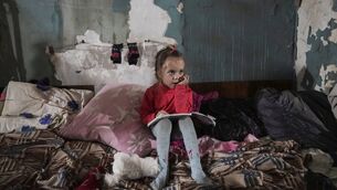 <p>I think of the girl in Ukraine doing her schoolwork while sitting in the shattered remains of a house. She looks like she is living in a post-apocalyptic wasteland. File photo: AP/Evgeniy Maloletka</p>
