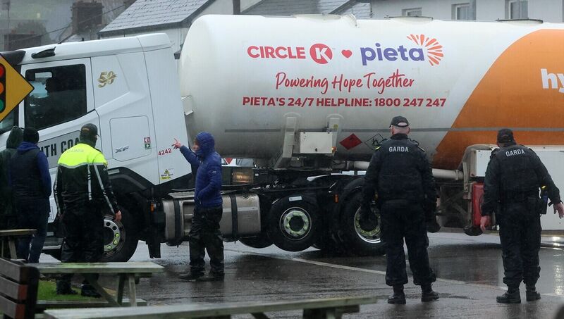 Gardaí escort a tanker at the Whitegate oil refinery in Cork on the fourth day of national fuel protests. The country is divided between supporting the protesters and accusing them of holding the 'country to ransom'. Picture: Brendan Gleeson/PA Gardaí escort a tanker at the Whitegate oil refinery in Cork on the fourth day of national fuel protests. The country is divided between supporting the protesters and accusing them of holding the 'country to ransom'. Picture: Brendan Gleeson/PA