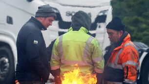 <p>Protesters take part in a blockade at a fuel depot in Foynes, Co Limerick, on the fourth day of a National Fuel Protest against rising fuel prices. Photo: Brendan Gleeson/PA Wire</p>