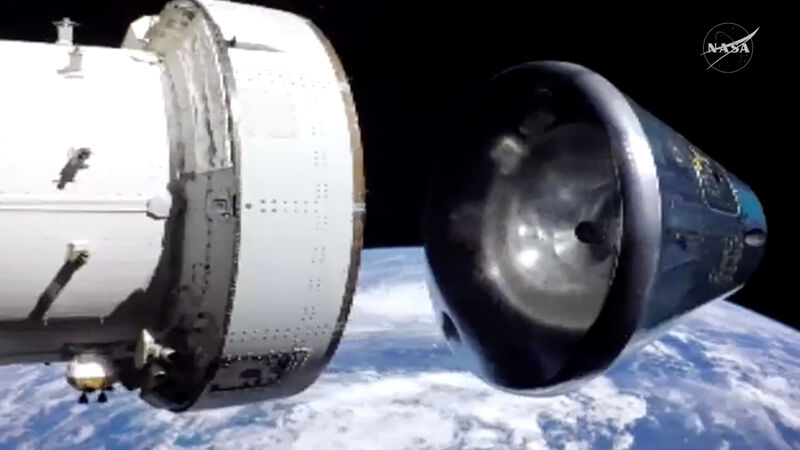In this image from video provided by NASA, the Artemis II Orion capsule, right, separates from the service module above the Earth in preparation for splash down in the Pacific Ocean, on Friday, April 10, 2026. (NASA via AP)