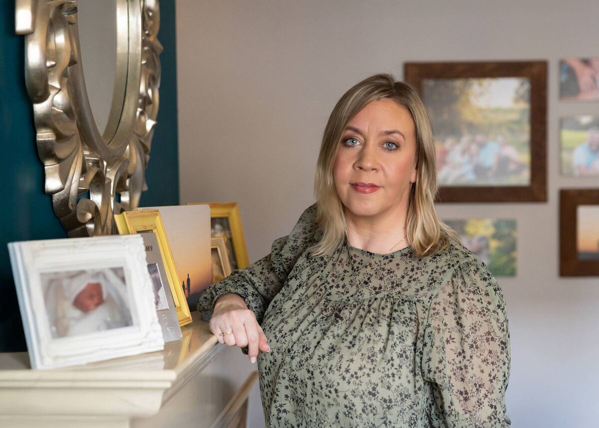 Volunteer photographer Michelle McCormack beside a photo a nurse took of her daughter Caoimhe before NILMDTS Ireland was established. Picture: Michelle McCormack/NILMDTS Ireland. Volunteer photographer Michelle McCormack beside a photo a nurse took of her daughter Caoimhe before NILMDTS Ireland was established. Picture: Michelle McCormack/NILMDTS Ireland.