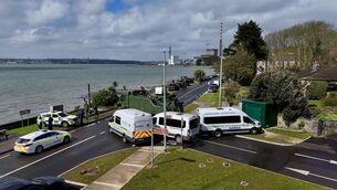 <p> An army heavy-lift recovery truck and garda vans are used to block the main road into Whitegate. The roadblock by gardaí was to prevent a vehicle entering the village after a number of gardai checkpoints were passed. Picture: Larry Cummins</p> <p> An army heavy-lift recovery truck and garda vans are used to block the main road into Whitegate. The roadblock by gardaí was to prevent a vehicle entering the village after a number of gardai checkpoints were passed. Picture: Larry Cummins</p>
