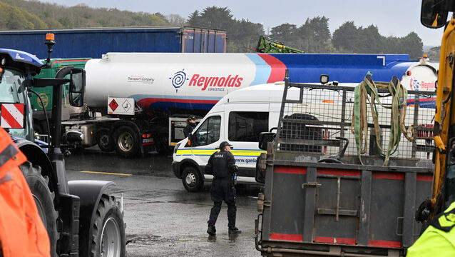 <p> Fuel trucks heading to the oil refinery under garda escort at Whitegate village on Saturday. Picture: Larry Cummins</p>
