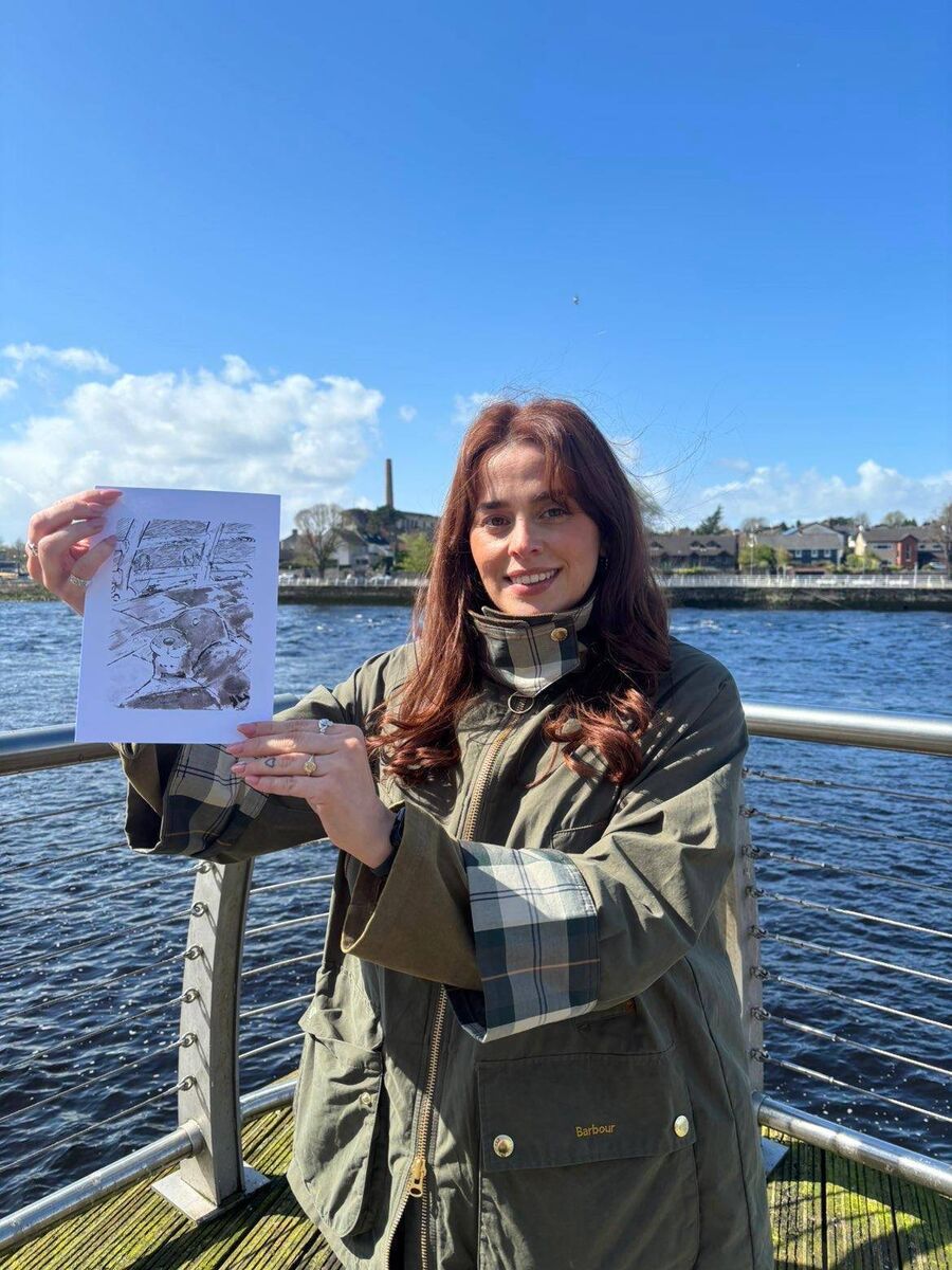 Shauna Cosgrave with artist Rímú's illustration of the distressed otter pup she found underneath her car in Limerick. Picture: WhatsApp