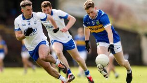<p>SURGING: Tipperary's Dáithi Hogan tries to break free of the pursuing Conor Ó Cuirrín of Waterford in Sunday's Munster SFC quarter-final tie at Cappoquin Logistics Fraher Field. Pic: Michael P Ryan/Sportsfile</p>