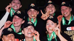 <p>TASTE IT: Trinity Meteors players celebrate their Domino's Women's Super League final win over UCC Glanmire at the National Basketball Arena. Pic: Tom Maher, Inpho</p>