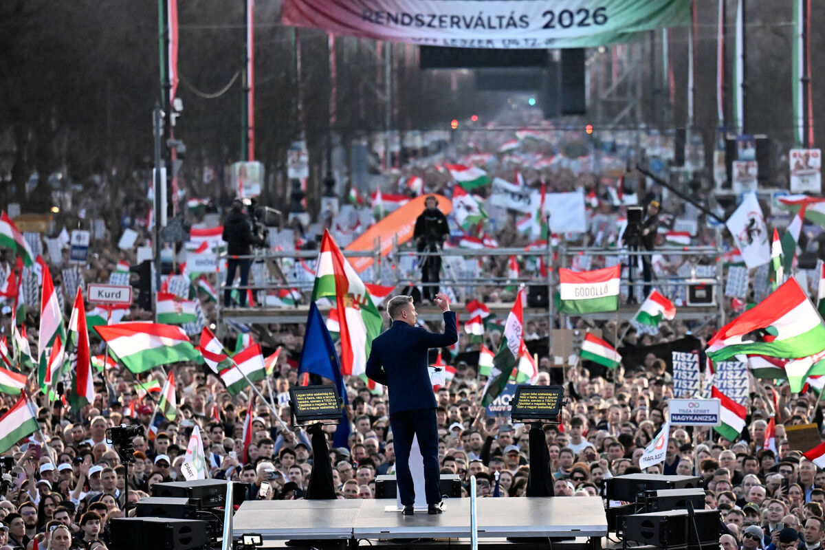 Opposition leader Peter Magyar, center, addresses his supporters during a march in Budapest, Sunday, March 15, 2026. (AP Photo/Denes Erdos)
