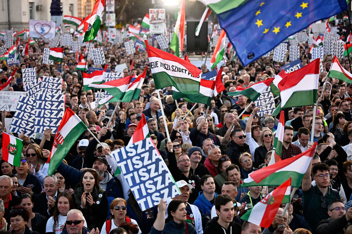 Supporters cheer as the opposition leader Peter Magyar addresses them during a march in Budapest, Sunday, March 15, 2026. (AP Photo/Denes Erdos)