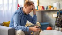 Frusrated redhead teenage boy after he lost the game while playing video games
