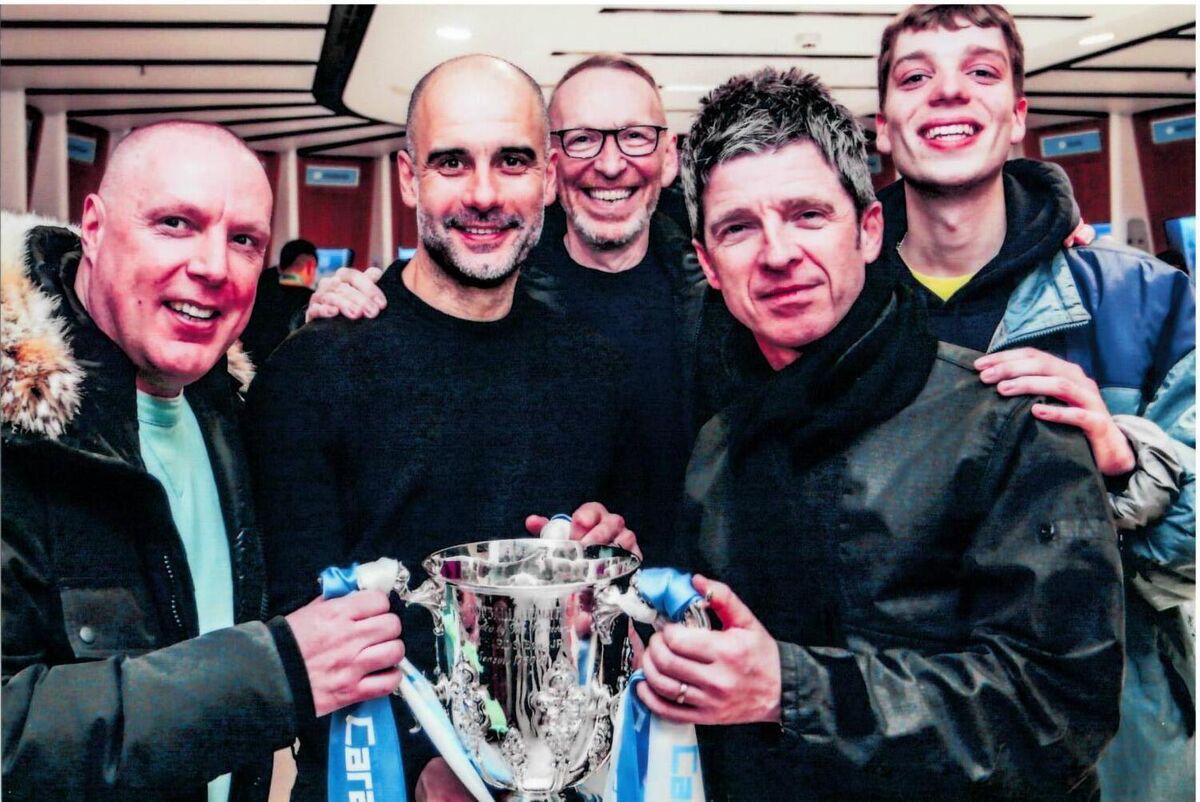 Mike Pickering celebrating a Manchester City trophy with Manchester Must Dance Noel Gallagher, Pep Guardiola with trophy cup 