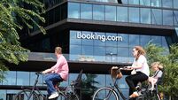 People ride bicycles near the Booking.com HQ in Amsterdam.