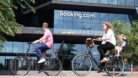 People ride bicycles near the Booking.com HQ in Amsterdam.