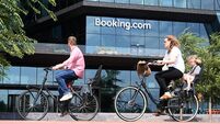 People ride bicycles near the Booking.com HQ in Amsterdam.