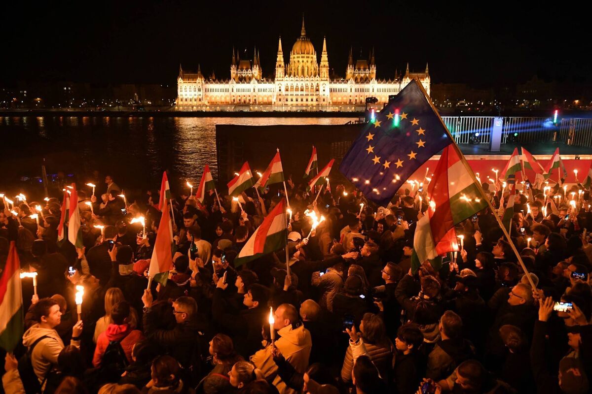 Supporters of the pro-European conservative Tisza party celebrate Peter Magyar's victory in Budapest on the banks on the river Danube with the Parliament building in the background. Photo: Ferenc Isza/AFP via Getty Images
