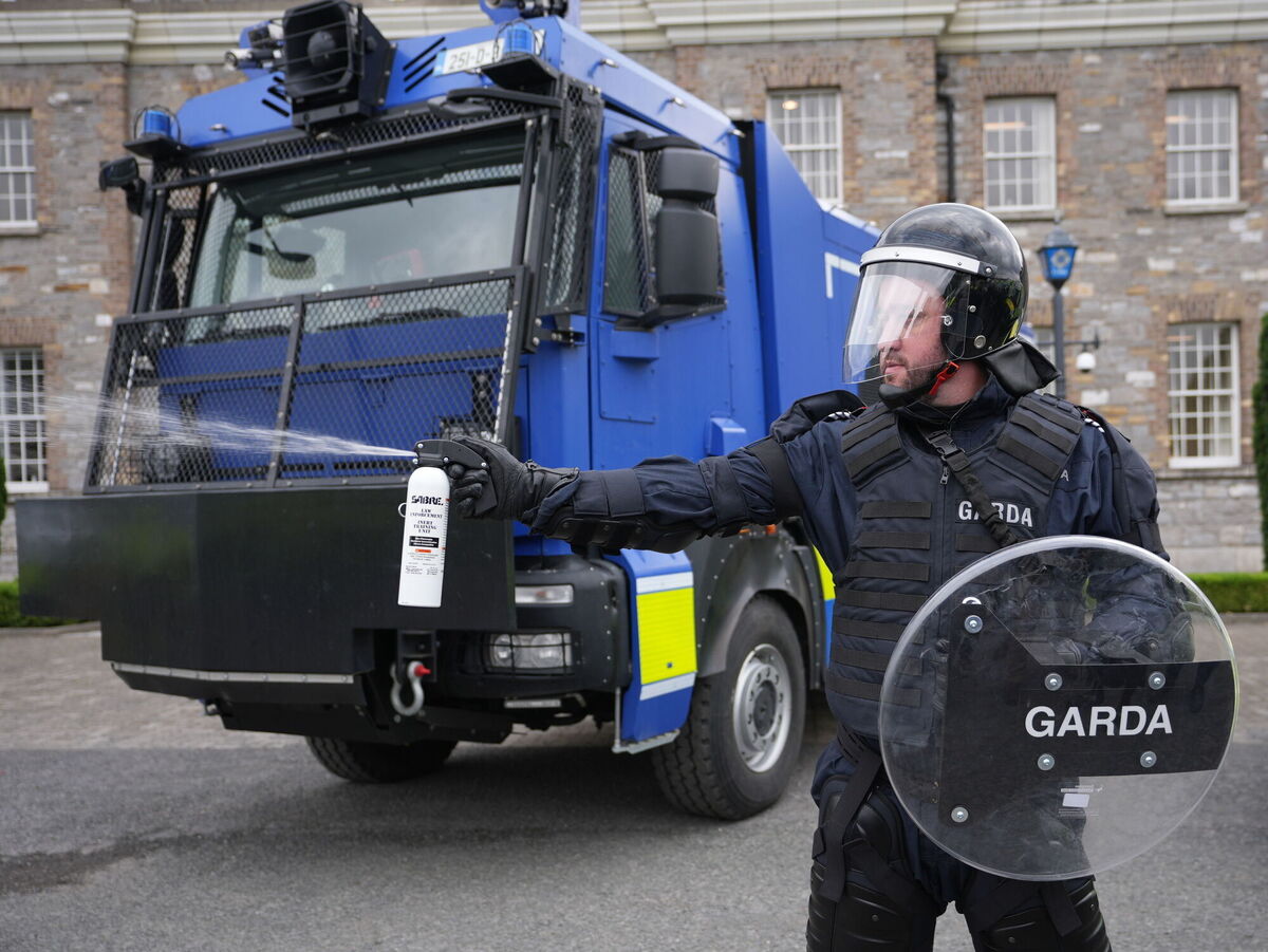 A member of the public order unit demonstrating the use of pepper spray next to a water cannon at Garda headquarters in Phoenix Park, Dublin last year. File picture: Niall Carson/PA 