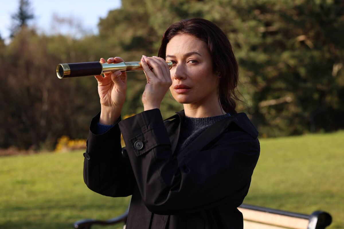 Olga Kurylenko as The Woman in Black in The Three Urns