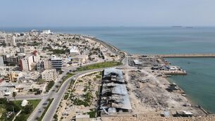 Reported damage on a fishing pier in the port of Qeshm island, Iran, backdropped by ships in the Strait of Hormuz (Asghar Besharati/AP) Reported damage on a fishing pier in the port of Qeshm island, Iran, backdropped by ships in the Strait of Hormuz (Asghar Besharati/AP)